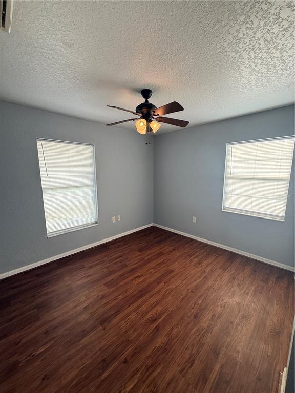 202 Owens Road Lake Wales, FL 33859 - Photo 12 of 17 a view of an empty room with wooden floor and a window