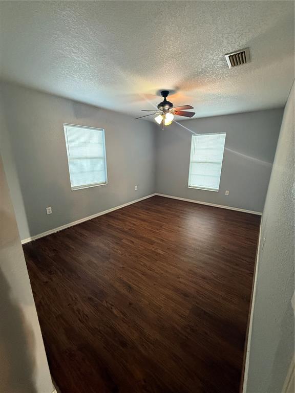 202 Owens Road Lake Wales, FL 33859 - Photo 14 of 17 an empty room with windows and chandelier fan