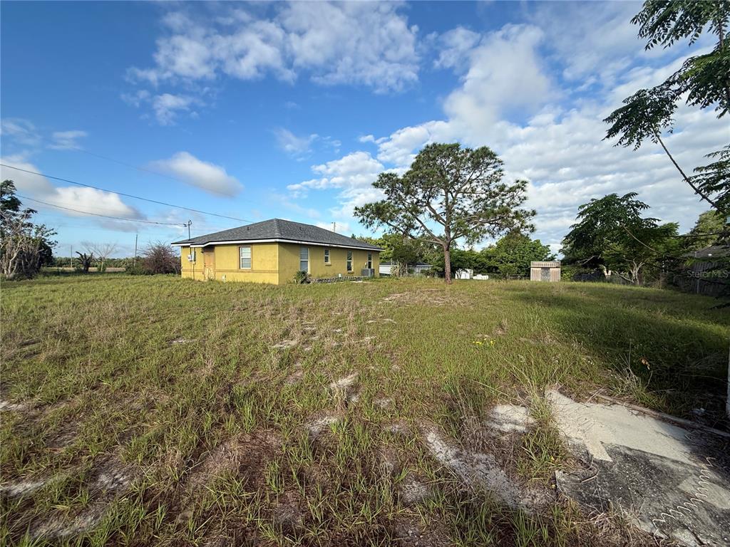 202 Owens Road Lake Wales, FL 33859 - Photo 17 of 17 a view of a big yard with table and chairs under an umbrella