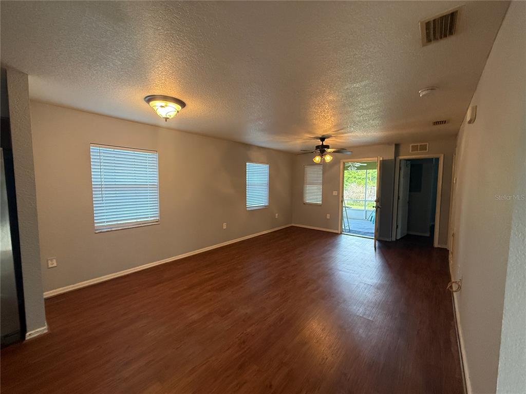 202 Owens Road Lake Wales, FL 33859 - Photo 4 of 17 an empty room with wooden floor and windows
