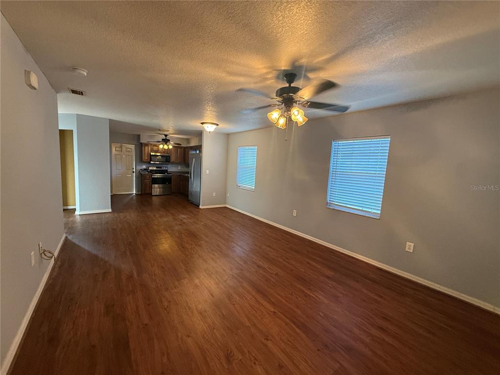 202 Owens Road Lake Wales, FL 33859 - Photo 5 of 17 wooden floor in an empty room with a window