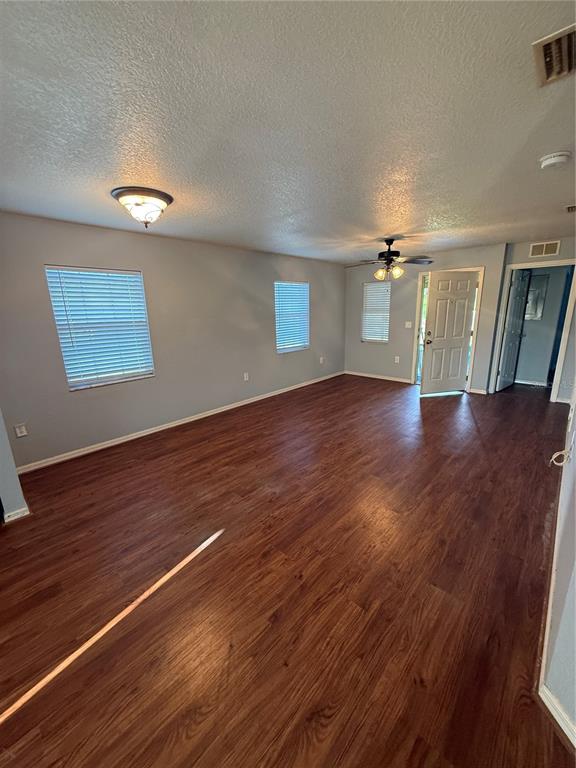 202 Owens Road Lake Wales, FL 33859 - Photo 8 of 17 an empty room with wooden floor and windows
