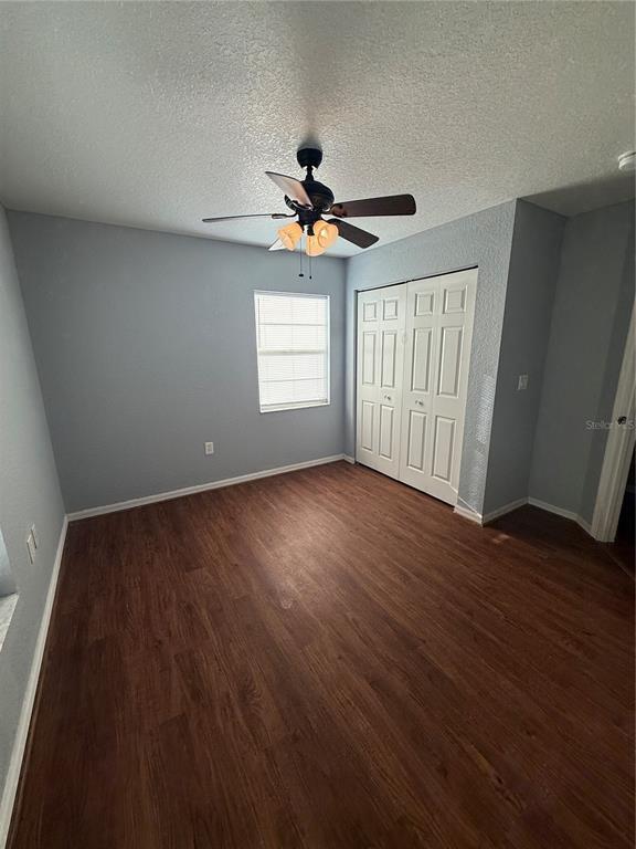 202 Owens Road Lake Wales, FL 33859 - Photo 9 of 17 a view of an empty room with a window and wooden floor
