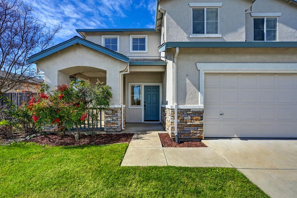 1619 7th Street Hughson, CA 95326 - Photo 2 of 61 a front view of a house with garden