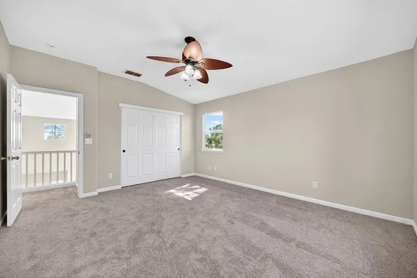 an empty room with windows and closet