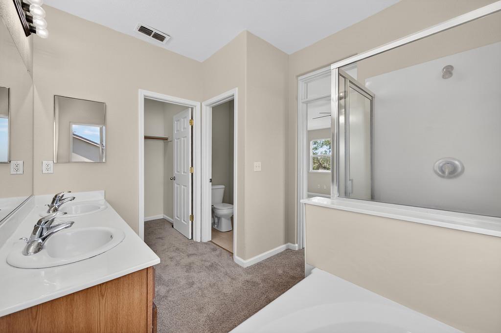 1619 7th Street Hughson, CA 95326 - Photo 32 of 61 a bathroom with a sink and a mirror