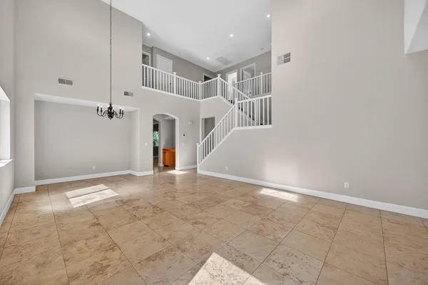 a kitchen with stainless steel appliances granite countertop a stove top oven a sink dishwasher a dining table and chairs with wooden floor
