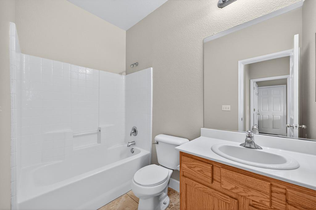 1619 7th Street Hughson, CA 95326 - Photo 46 of 61 a bathroom with a granite countertop sink toilet and shower