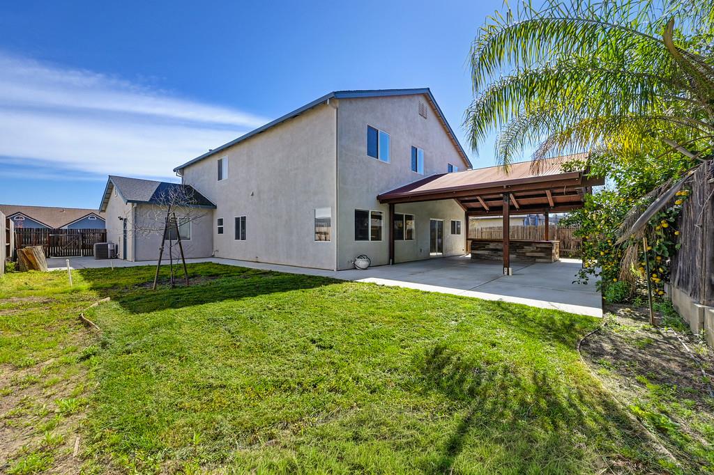 1619 7th Street Hughson, CA 95326 - Photo 50 of 61 a view of a house with swimming pool and a yard