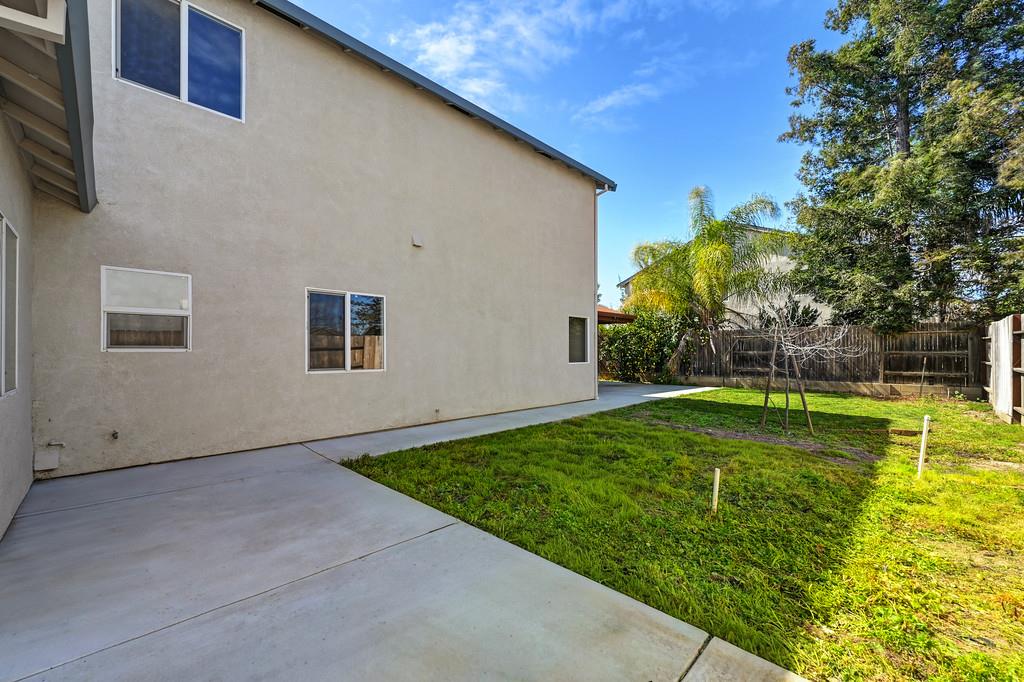 1619 7th Street Hughson, CA 95326 - Photo 60 of 61 a view of a backyard with plants and a patio
