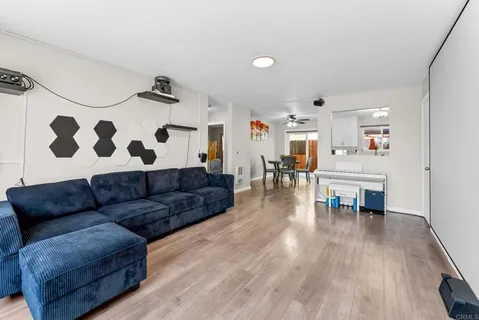 a living room with furniture and wooden floor