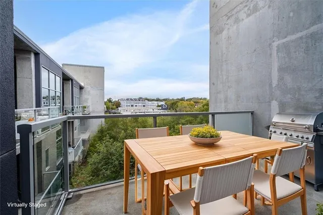 a view of a patio with a table and chairs and potted plants