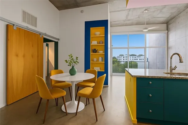 a view of a dining room with furniture and window