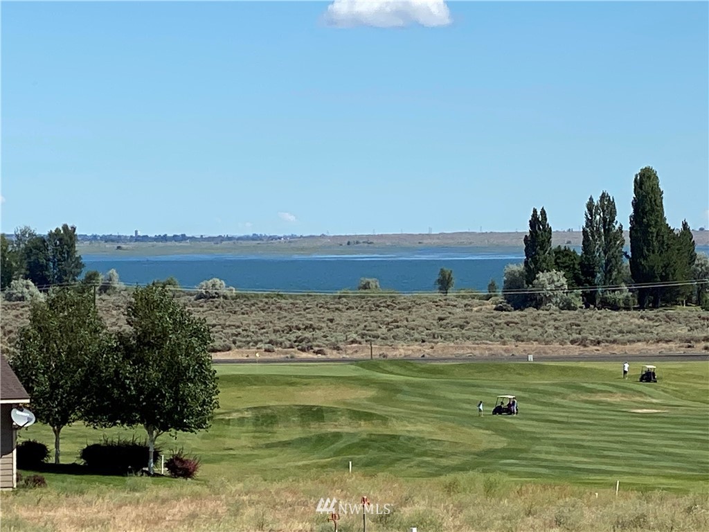 a view of a lake with houses in back