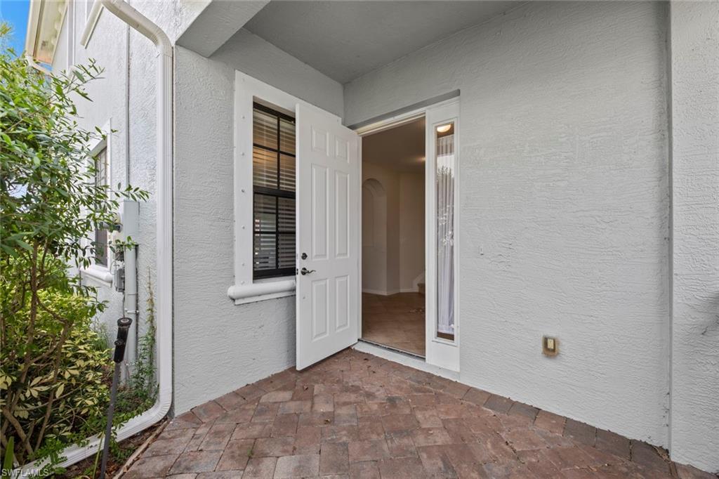 15594 Summit Pl Circle, Unit 402 Naples, FL 34119 - Photo 20 of 45 front view of a house with a yard