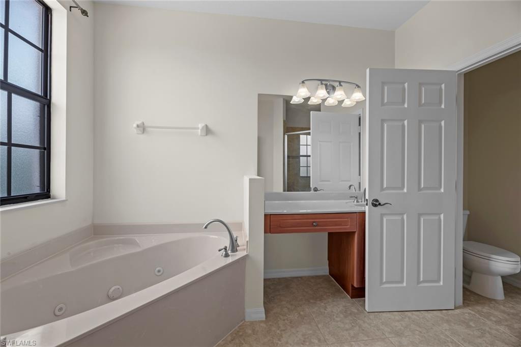 15594 Summit Pl Circle, Unit 402 Naples, FL 34119 - Photo 21 of 45 a bathroom with a bathtub and a sink