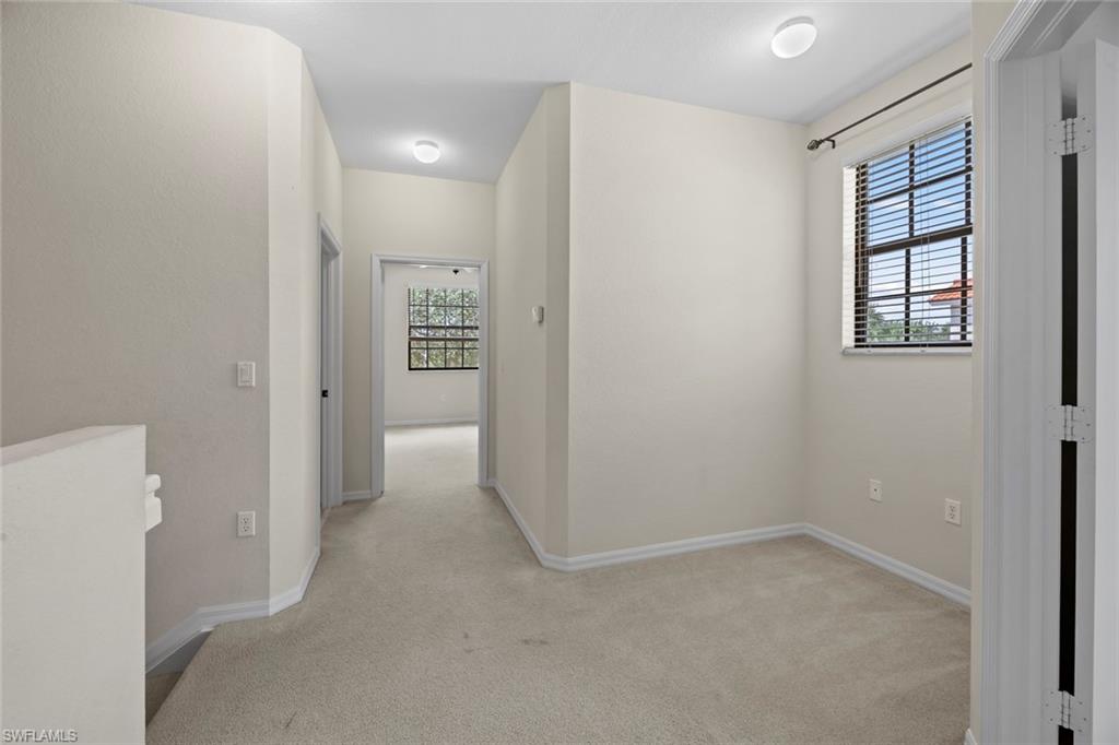 15594 Summit Pl Circle, Unit 402 Naples, FL 34119 - Photo 30 of 45 an empty room with windows and closet