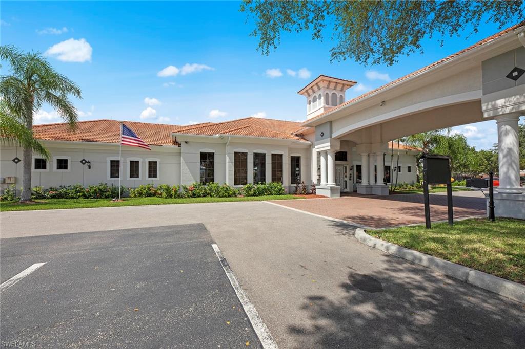 15594 Summit Pl Circle, Unit 402 Naples, FL 34119 - Photo 39 of 45 a front view of a building with a garden