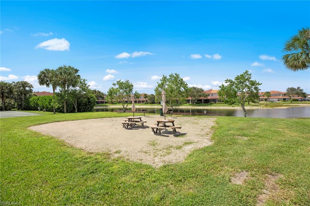 15594 Summit Pl Circle, Unit 402 Naples, FL 34119 - Photo 44 of 45 a view of a swimming pool with a garden and trees