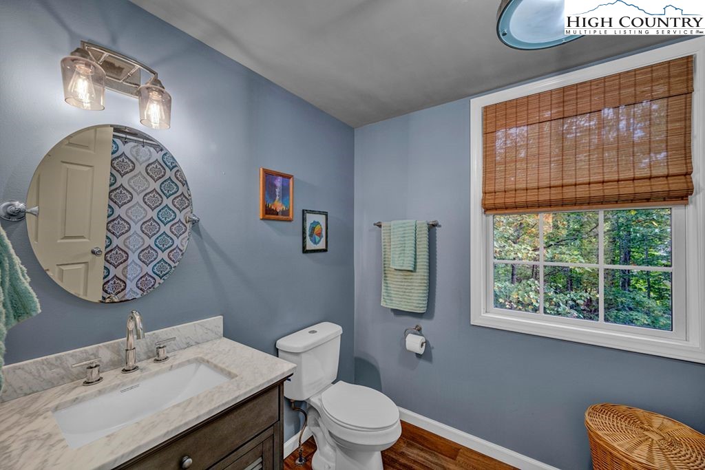 607 Charter Hills Road Beech Mountain, NC 28604 - Photo 14 of 31 a bathroom with a sink a toilet and a mirror