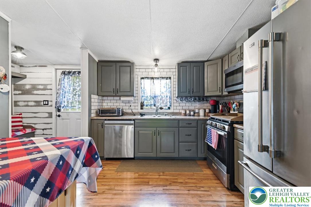 634 Main Road Lehighton, PA 18235 - Photo 9 of 39 A well-equipped kitchen boasts durable hardwood flooring and sleek stainless steel appliances.