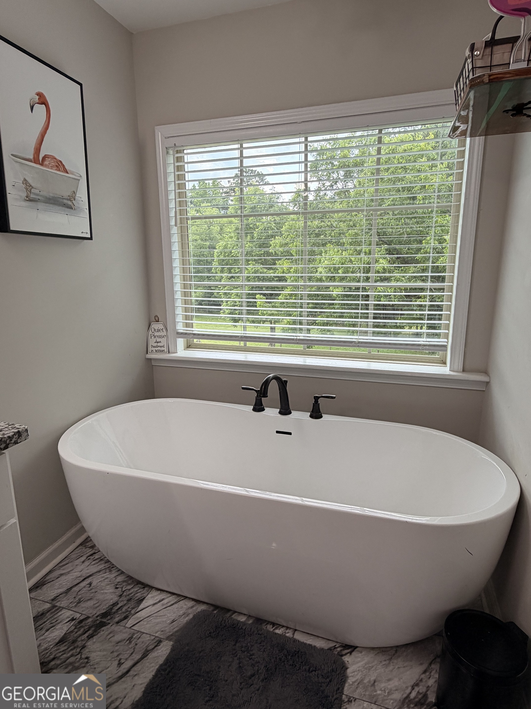 892 Perimeter Road Monticello, GA 31064 - Photo 26 of 38 a white bath tub sitting in a bathroom next to a window