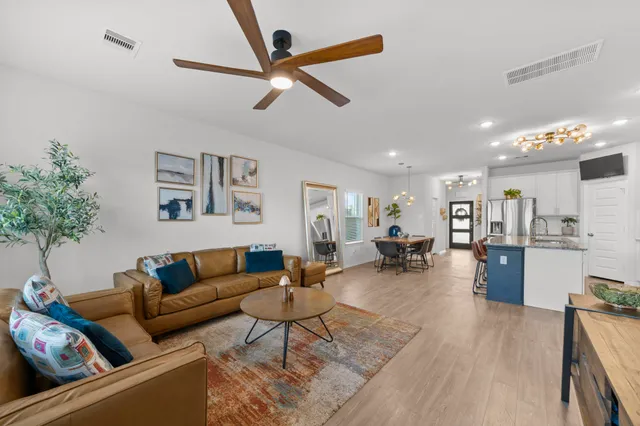 a living room with furniture and kitchen view