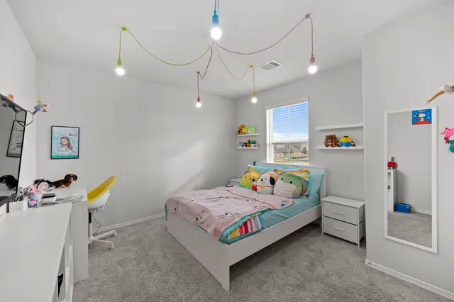 a bedroom that has a bed and a table in it