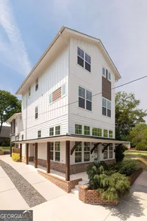 a front view of a building with a garden
