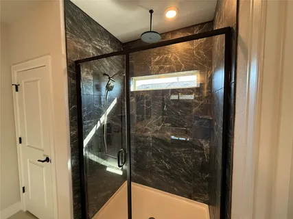 a bathroom with a granite countertop double vanity sink and a mirror