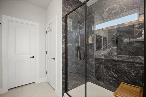 a bathroom with a glass shower door