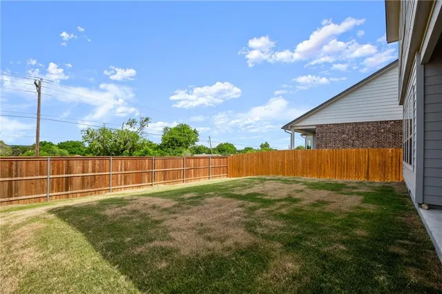 a bathroom with a granite countertop bathtub sink vanity mirror and toilet