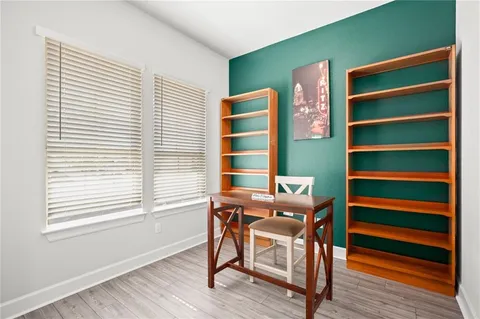 a view of a workspace with furniture and a window