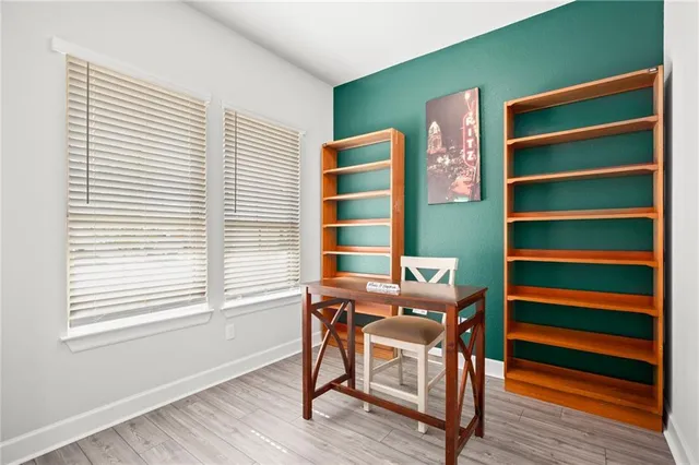 a view of a workspace with furniture and a window
