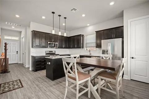 a bathroom with a granite countertop sink and a window