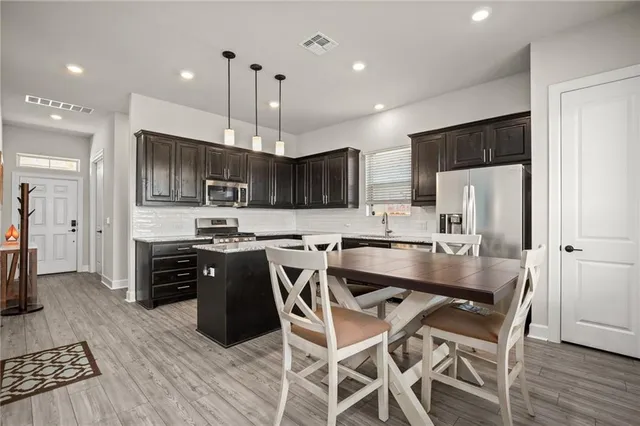 a bathroom with a granite countertop sink and a window
