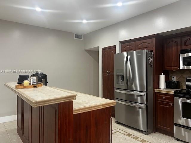 16131 Southwest 79th Terrace Miami, FL 33193 - Photo 12 of 32 a kitchen with a refrigerator and a stove