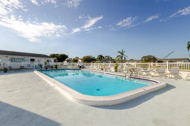a view of an ocean with boats and trees around