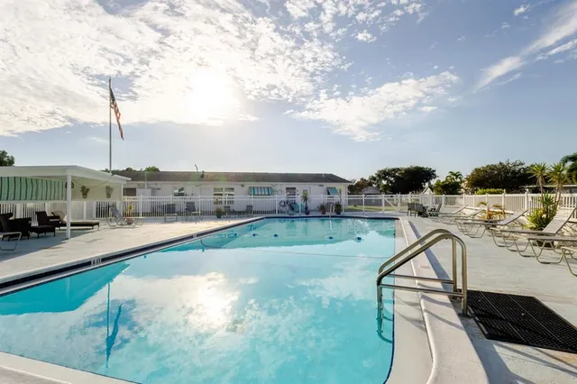 a view of a swimming pool with a yard