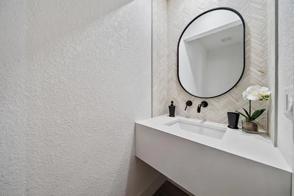 a bathroom with a sink and a mirror