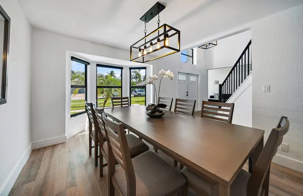 a view of a dining room with furniture window and wooden floor