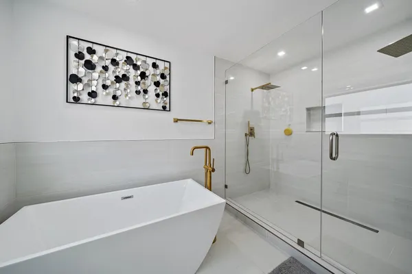 a bathroom with a bathtub and a shower