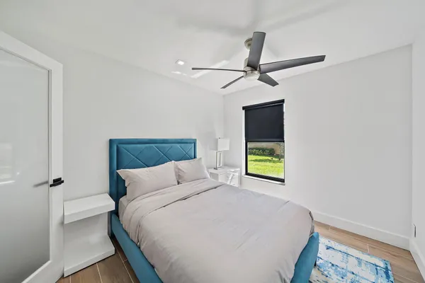 a bedroom with a bed and a window