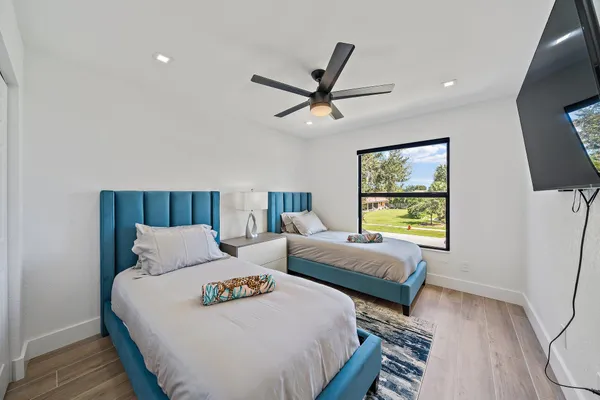 a bedroom with two beds and a window