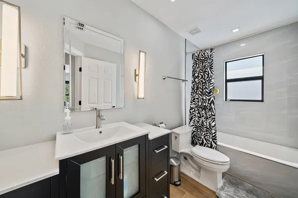 a bathroom with a sink toilet and shower