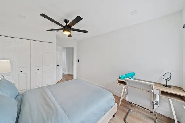 a bedroom with a bed and a chandelier