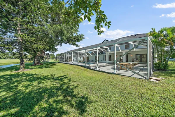 a view of a house with backyard porch and sitting area