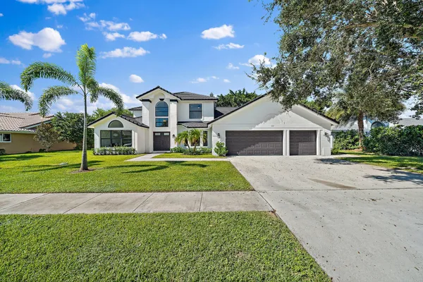 a front view of house with yard and green space