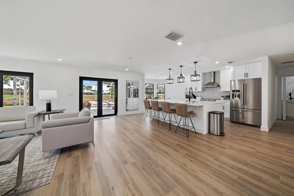 a living room with furniture and a wooden floor