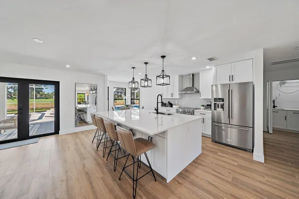 a kitchen with stainless steel appliances a white stove top oven and refrigerator